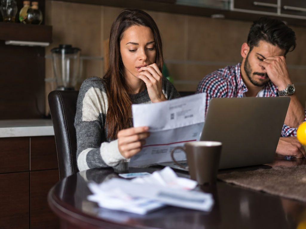 woman and man looking at electric bill